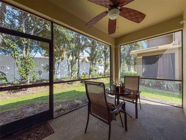 a dining room with furniture and a floor to ceiling window