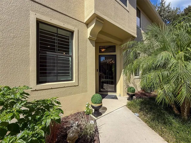 a backyard of a house with outdoor seating and plants