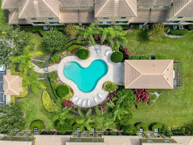 an aerial view of residential houses with outdoor space and street view
