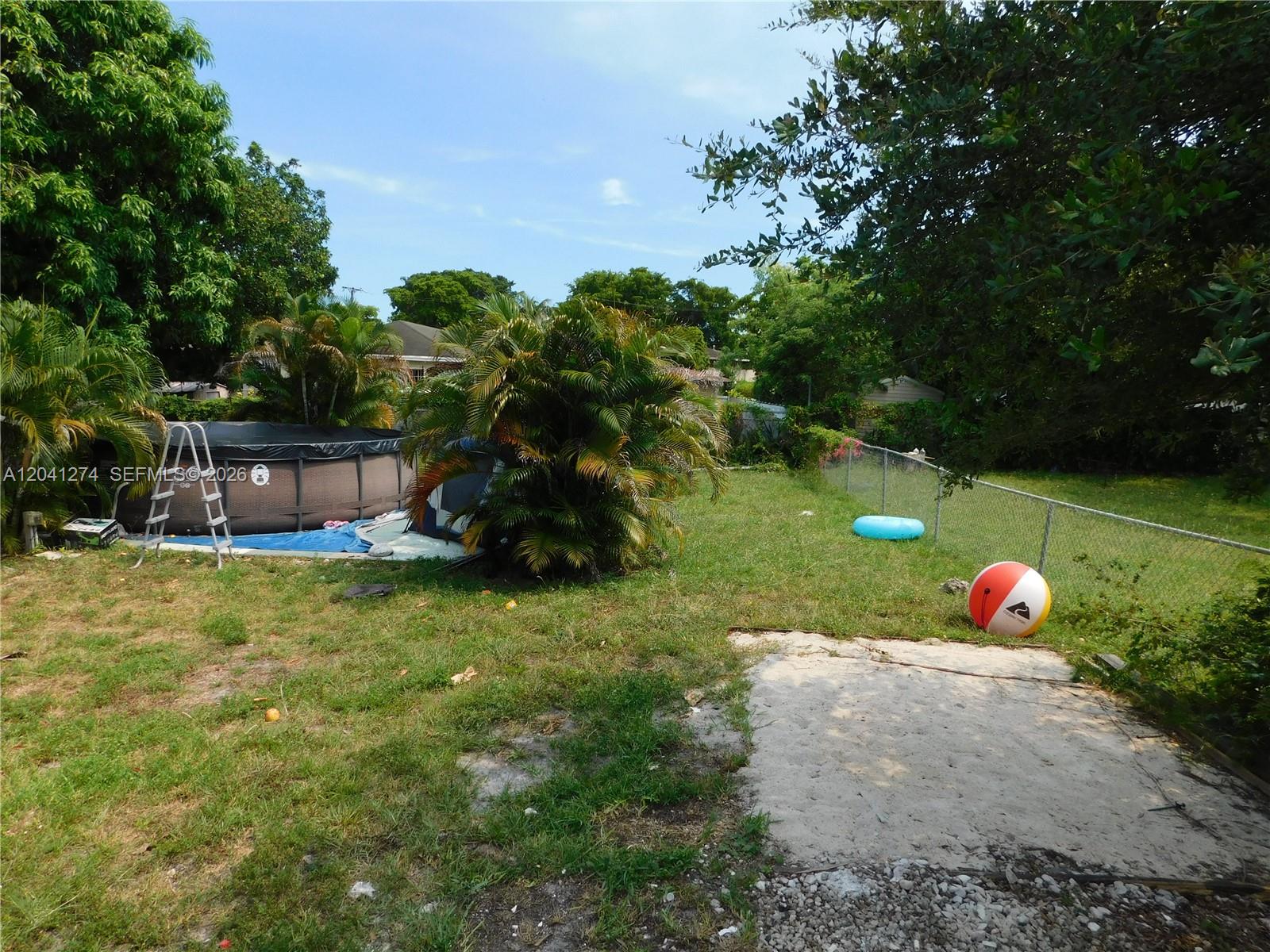 2230 Northwest 58th Street, Unit B Miami, FL 33142 - Photo 16 of 18 a view of a table and chairs in the garden