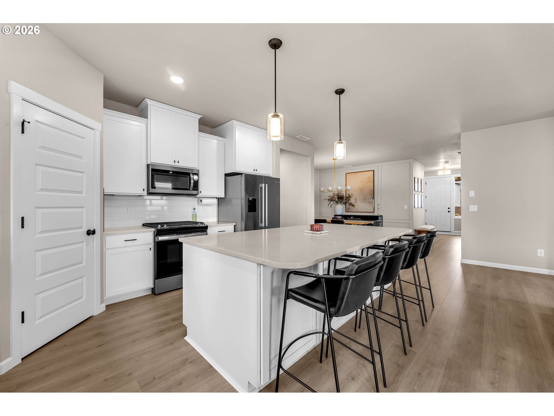 2814 Northwest 8th Place Battle Ground, WA 98604 - Photo 21 of 41 a kitchen with stainless steel appliances kitchen island granite countertop a table chairs and a refrigerator