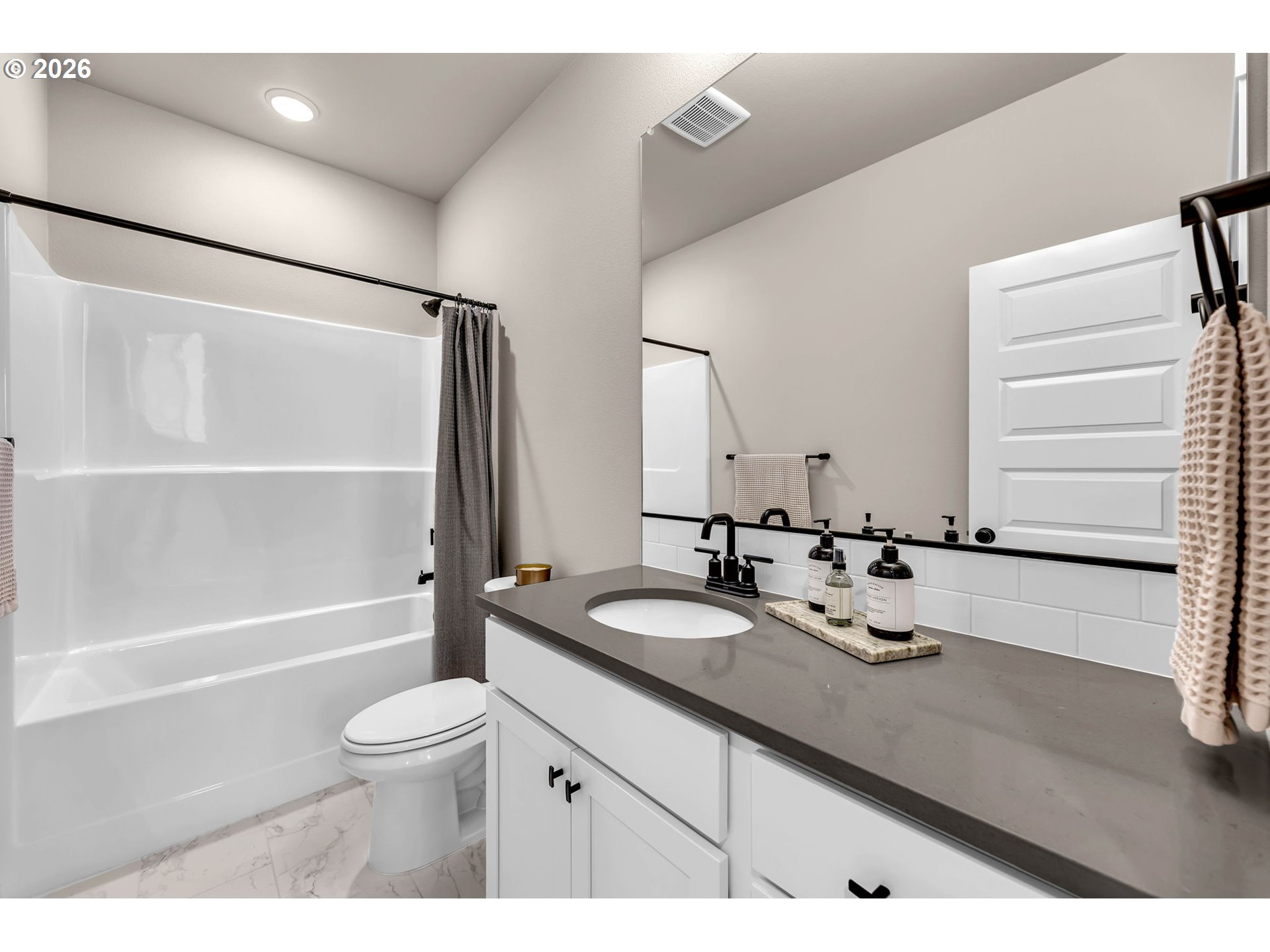 2814 Northwest 8th Place Battle Ground, WA 98604 - Photo 28 of 41 a bathroom with a granite countertop sink toilet mirror and bathtub