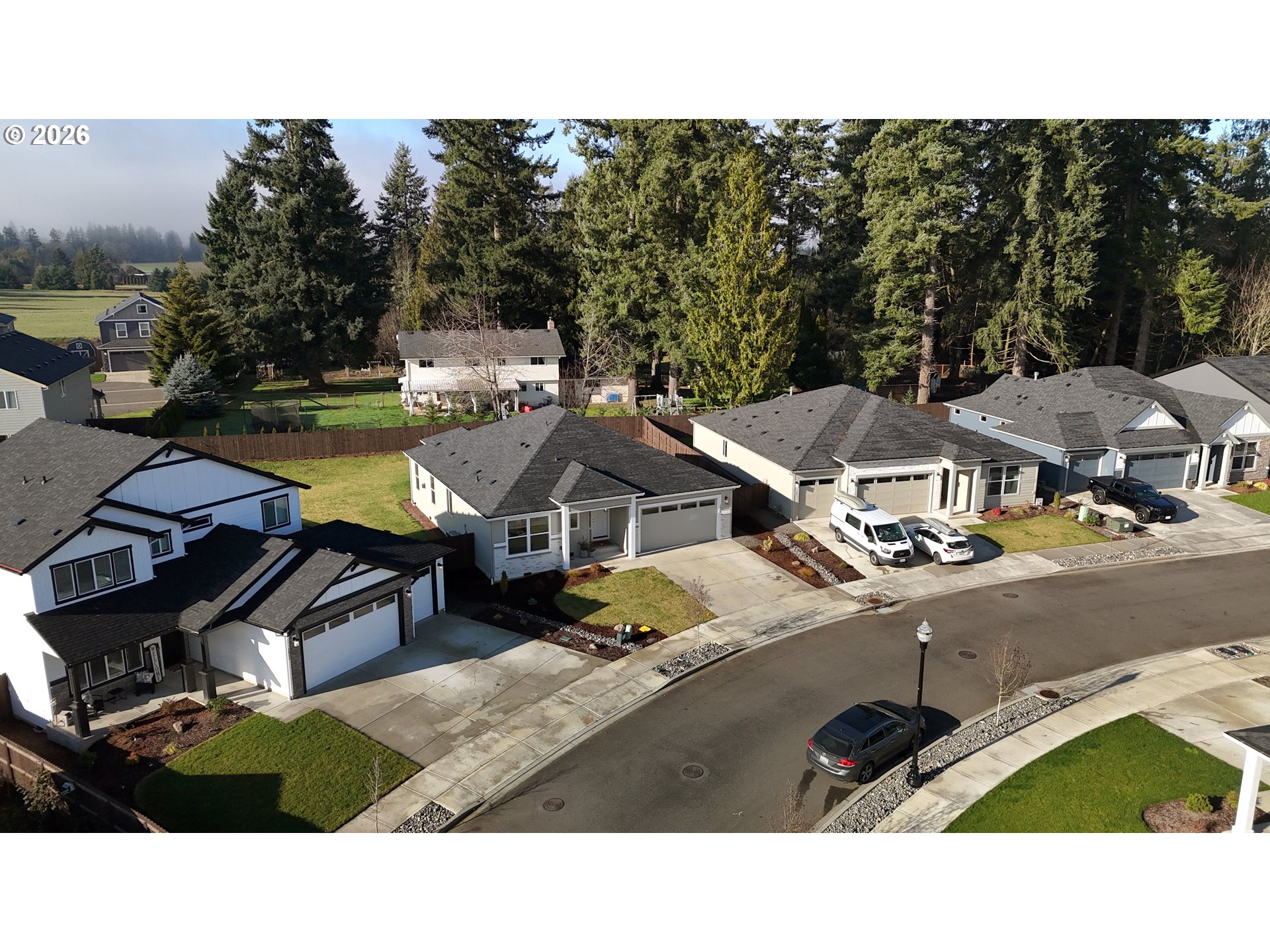 2814 Northwest 8th Place Battle Ground, WA 98604 - Photo 40 of 41 a view of a patio with table and chairs under an umbrella with wooden fence