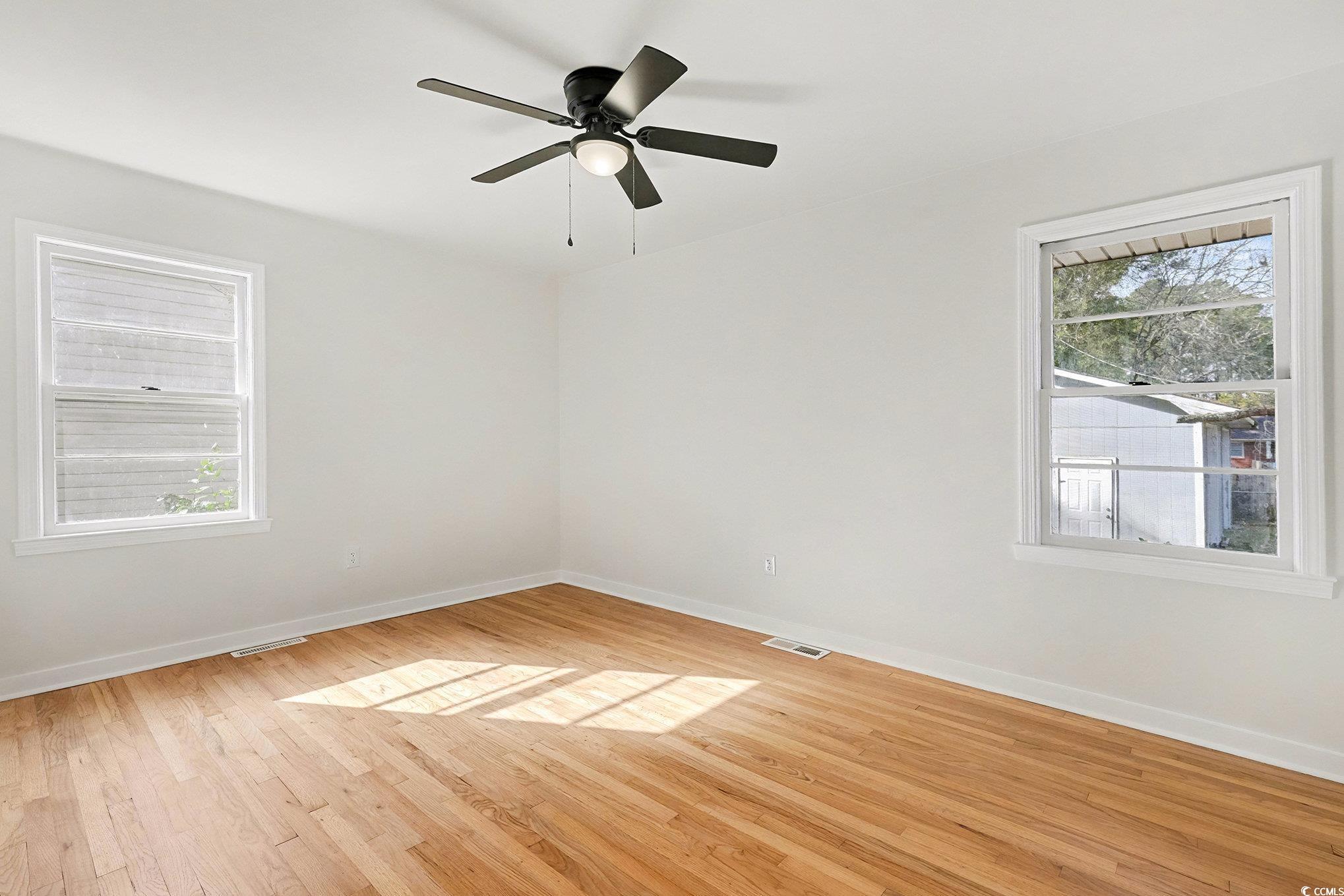 1300 Anderson Street Conway, SC 29526 - Photo 11 of 21 Spare room with light wood-style flooring, healthy amount of natural light, and a ceiling fan