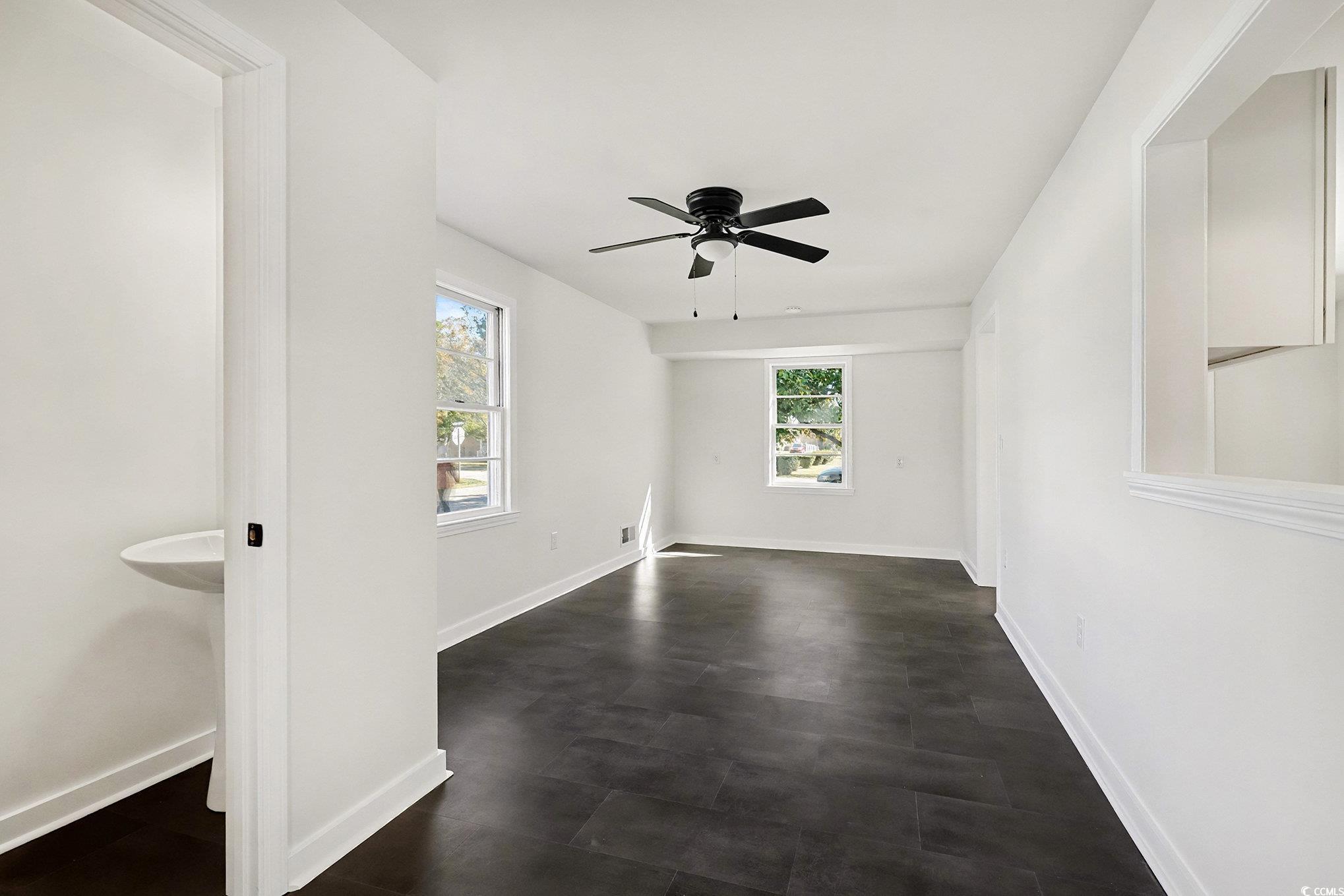 1300 Anderson Street Conway, SC 29526 - Photo 16 of 21 Empty room with a ceiling fan and dark flooring