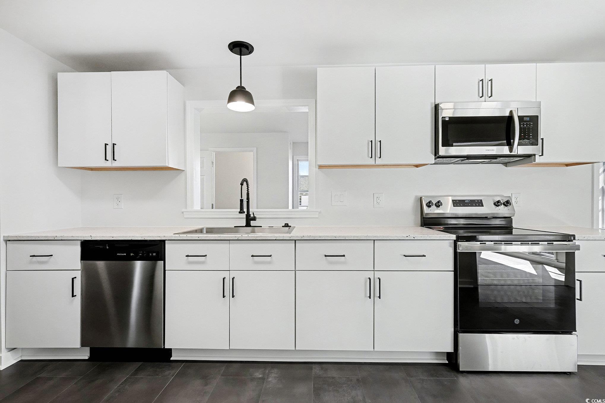 1300 Anderson Street Conway, SC 29526 - Photo 2 of 21 Kitchen featuring stainless steel appliances, white cabinets, and hanging light fixtures