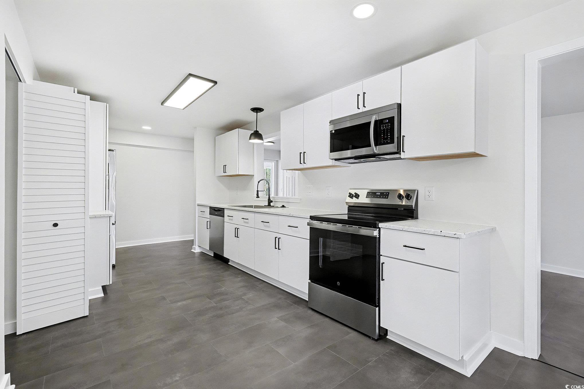 1300 Anderson Street Conway, SC 29526 - Photo 4 of 21 Kitchen featuring stainless steel appliances, white cabinets, recessed lighting, and hanging light fixtures