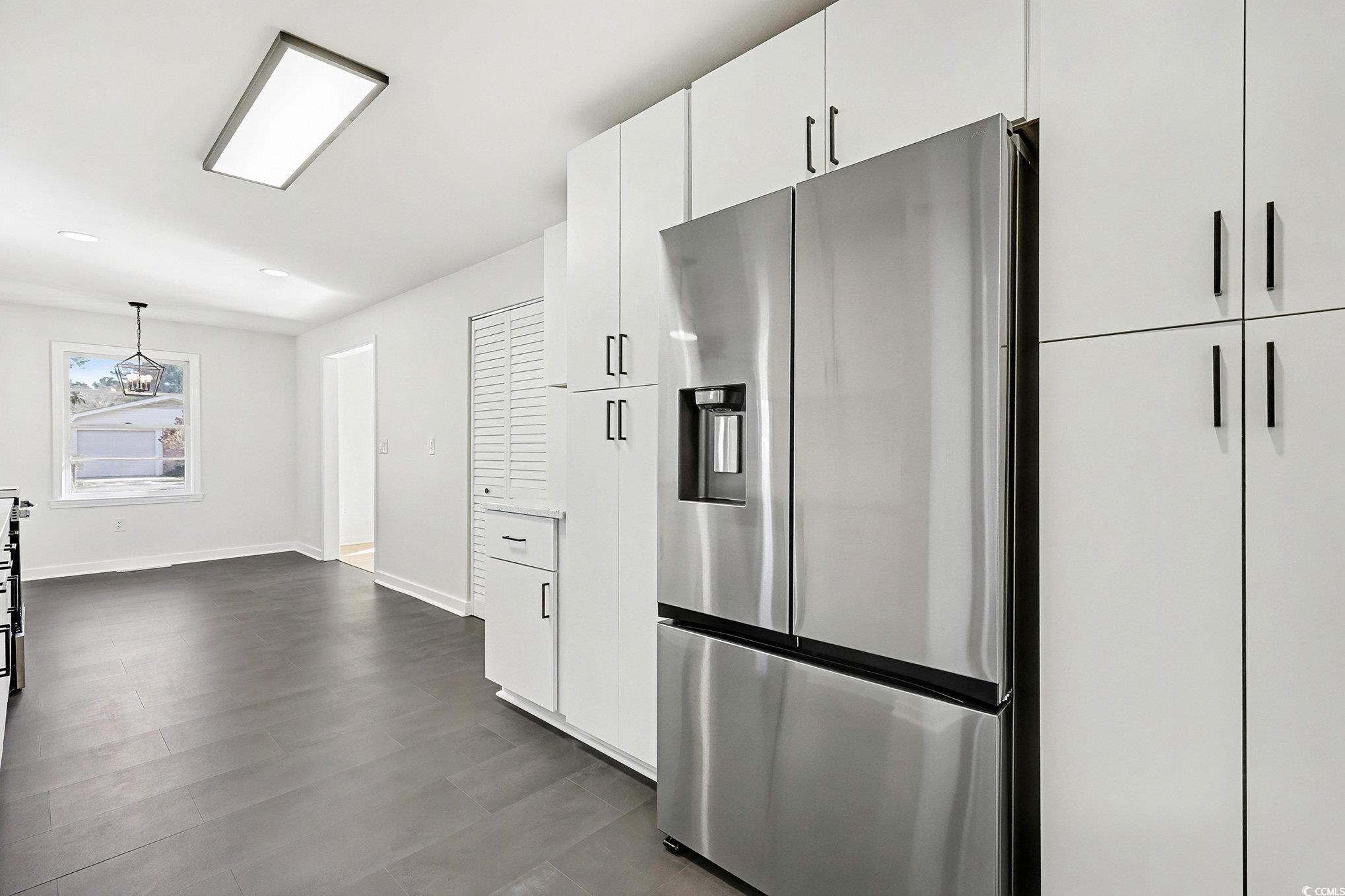 1300 Anderson Street Conway, SC 29526 - Photo 5 of 21 Kitchen featuring stainless steel fridge, white cabinets, pendant lighting, and light countertops