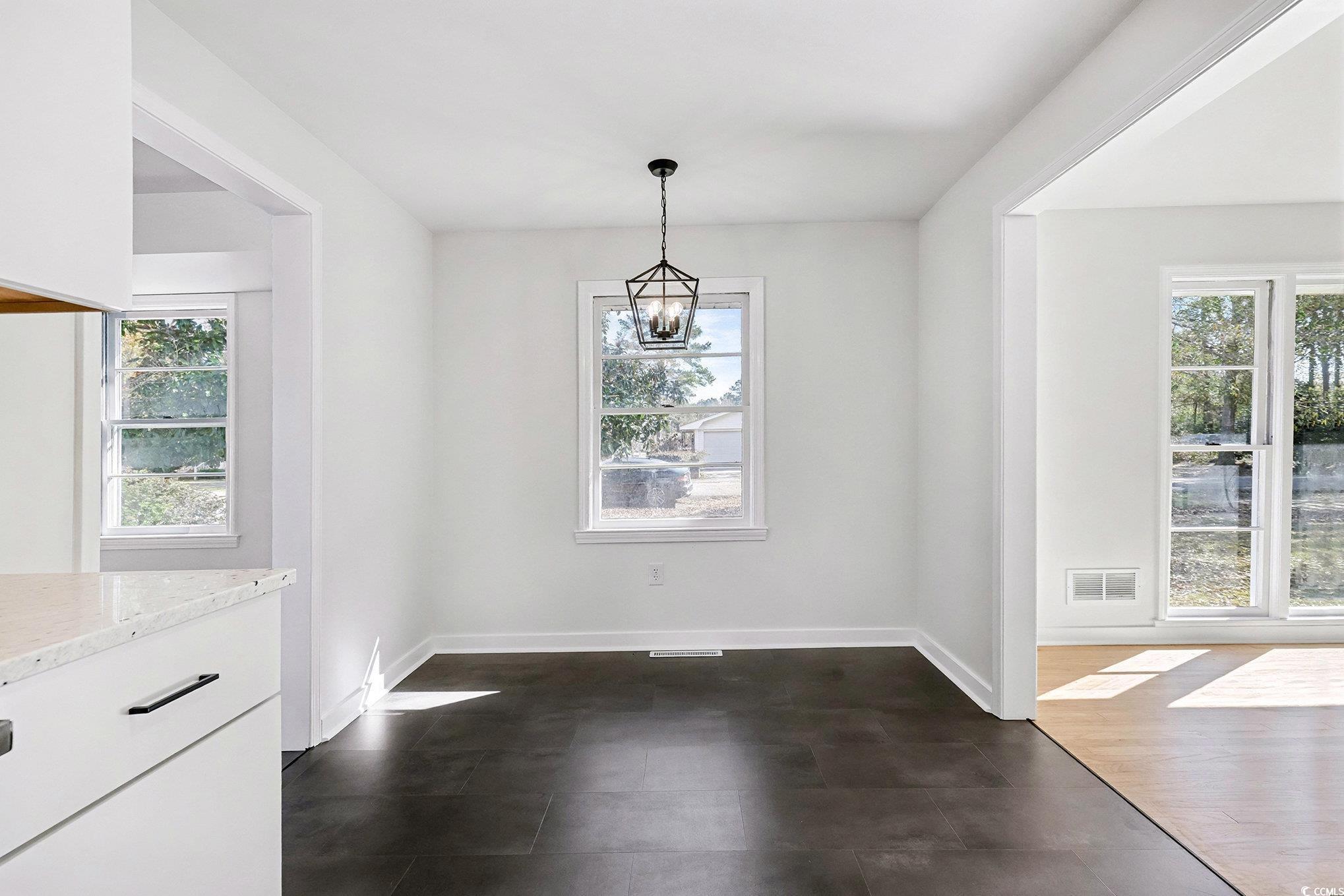 1300 Anderson Street Conway, SC 29526 - Photo 6 of 21 Unfurnished dining area featuring a chandelier and baseboards