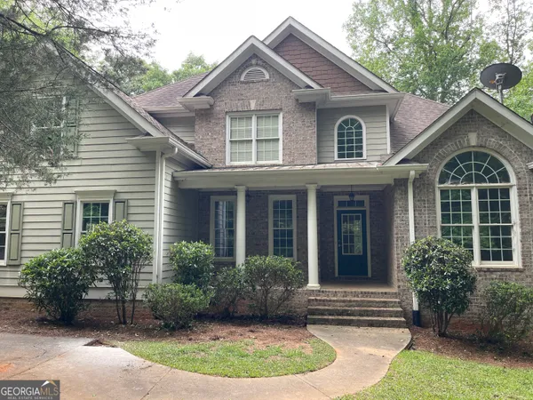 a front view of a house with a garden