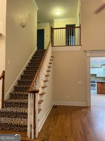 a view of an entryway with wooden floor