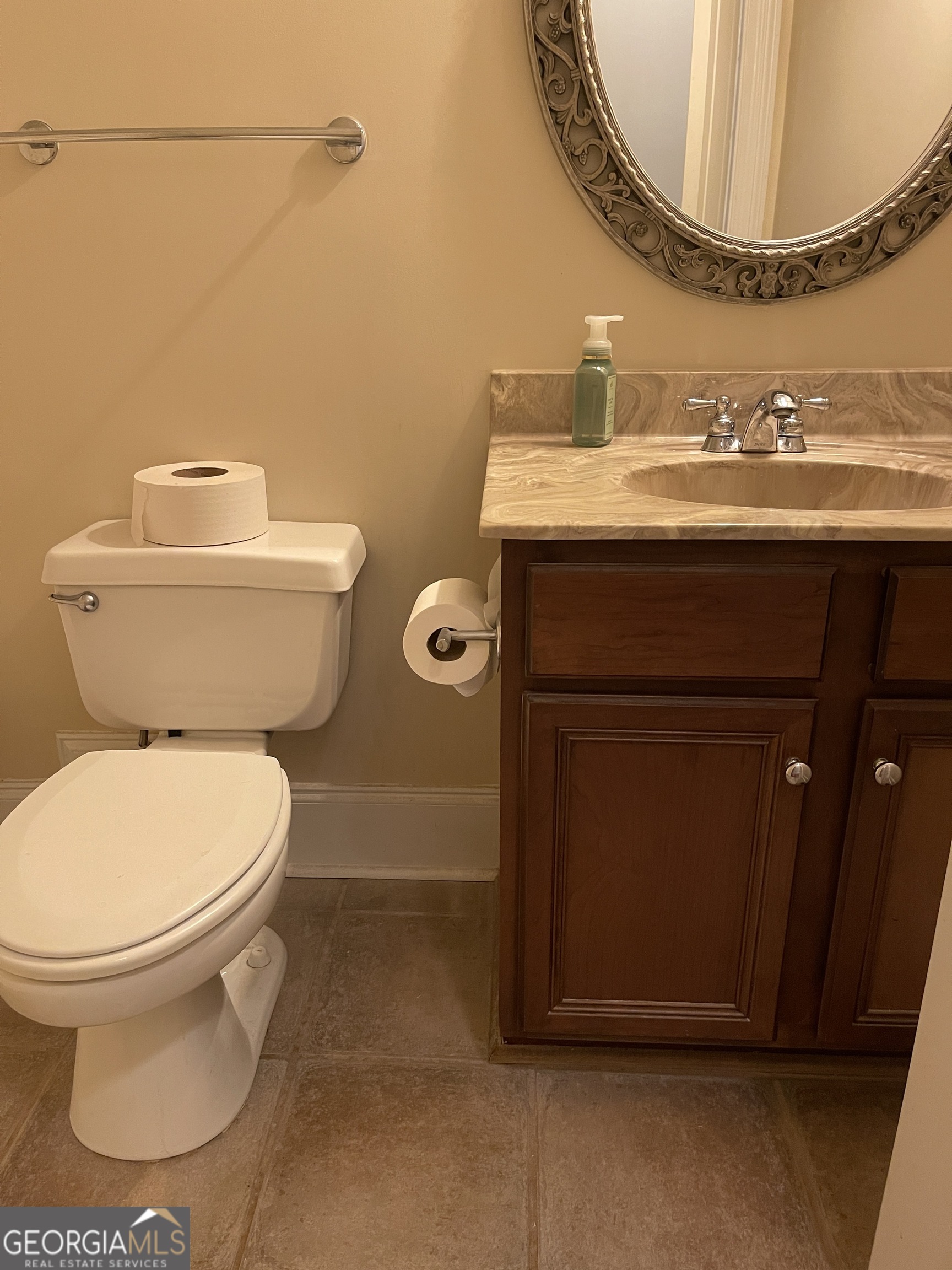 3910 Barnett Shoals Road Athens, GA 30605 - Photo 18 of 30 a bathroom with a toilet a sink and a mirror
