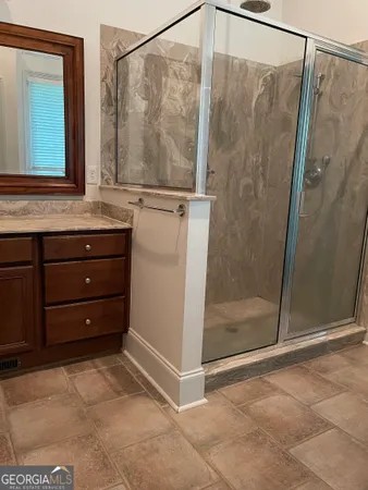 a bathroom with a shower and a sink