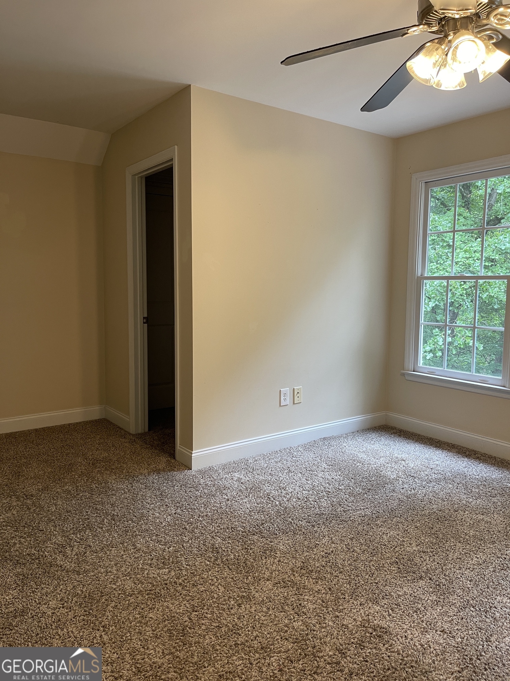 3910 Barnett Shoals Road Athens, GA 30605 - Photo 27 of 30 a view of an empty room with window and chandelier fan