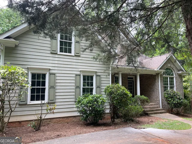 a front view of a house with garden
