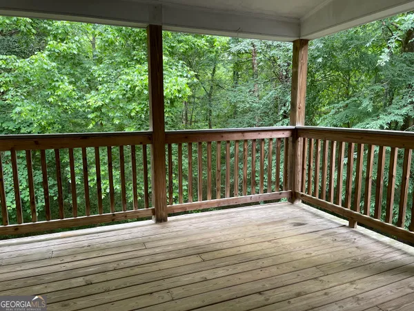 a view of balcony with wooden floor