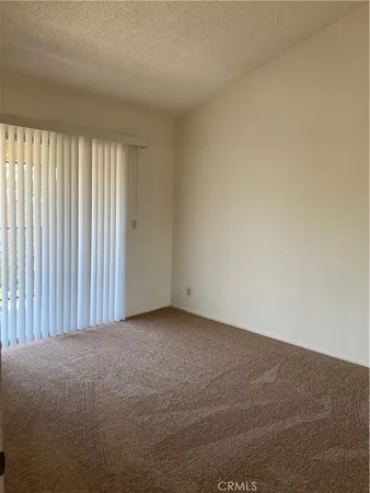 a view of an empty room and a window