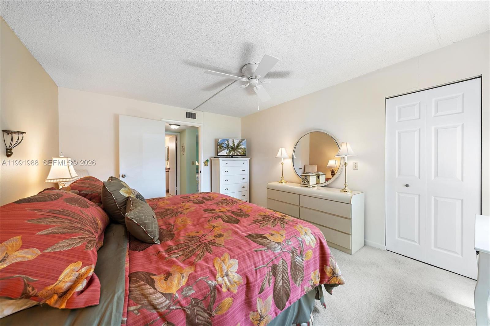 301 Pine Ridge Circle, Unit C1 Greenacres, FL 33463 - Photo 17 of 30 a bedroom with a bed and a dresser