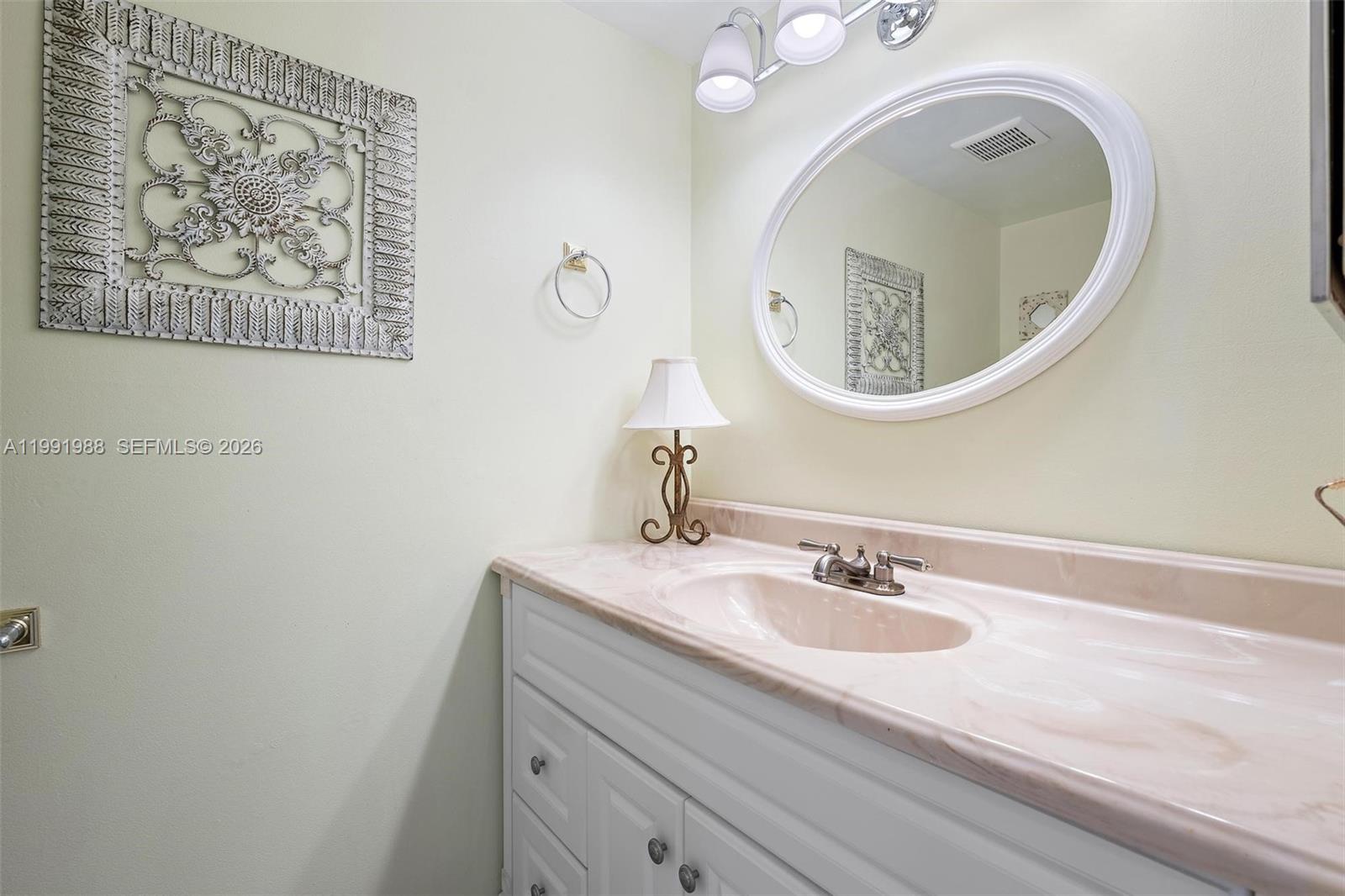 301 Pine Ridge Circle, Unit C1 Greenacres, FL 33463 - Photo 21 of 30 a bathroom with a sink and a mirror