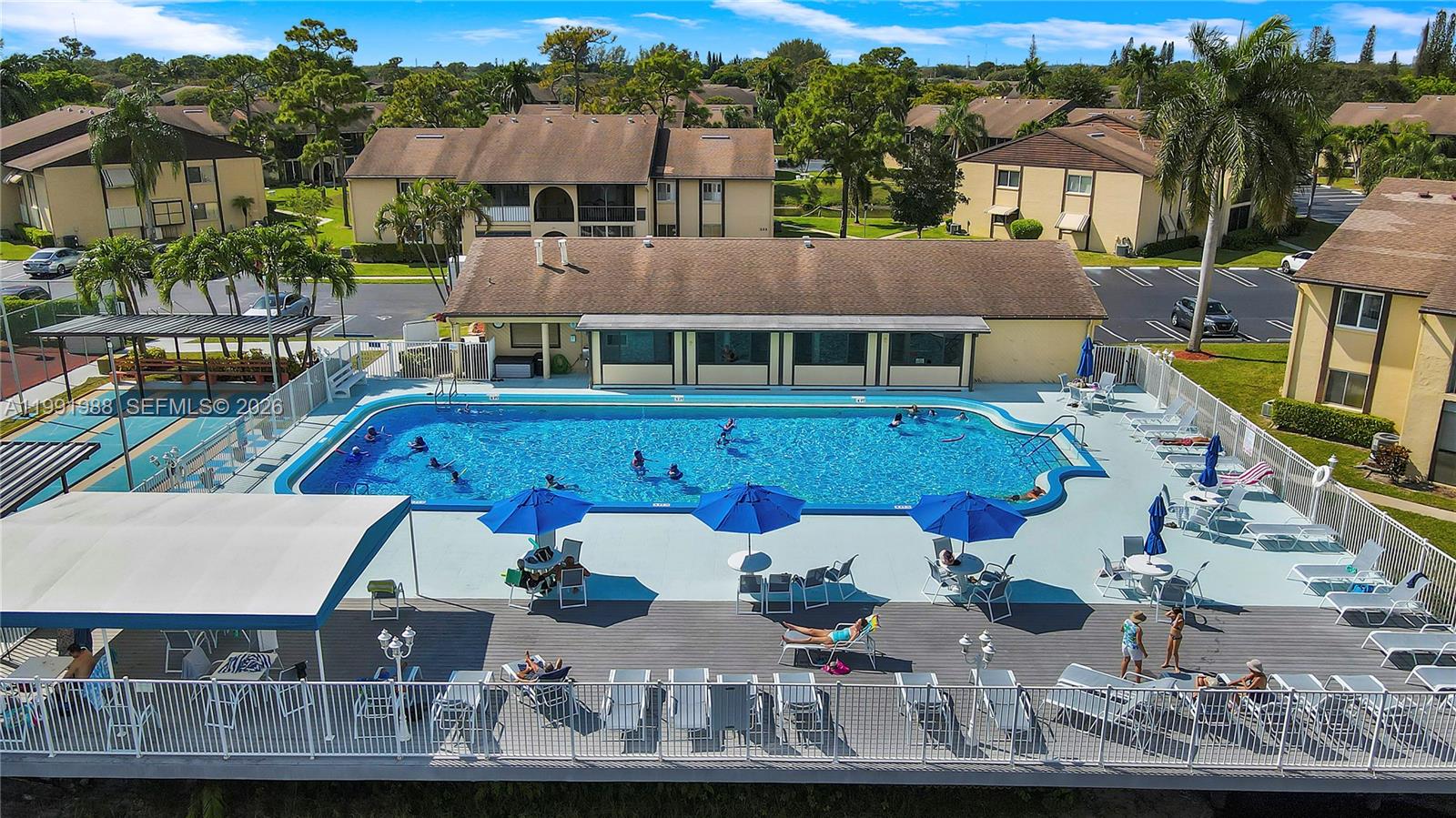 301 Pine Ridge Circle, Unit C1 Greenacres, FL 33463 - Photo 24 of 30 an aerial view of multiple houses with a yard