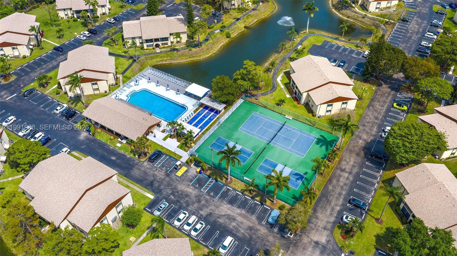 301 Pine Ridge Circle, Unit C1 Greenacres, FL 33463 - Photo 25 of 30 an aerial view of a house with a yard and a garden