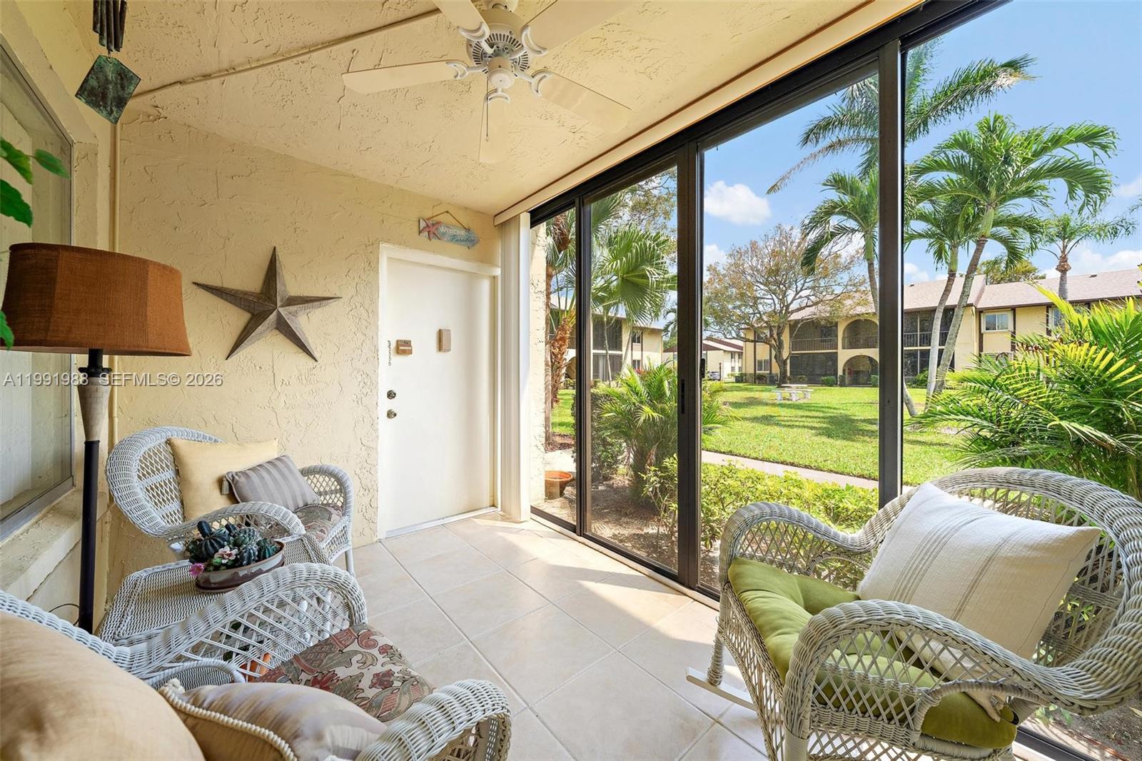 301 Pine Ridge Circle, Unit C1 Greenacres, FL 33463 - Photo 4 of 30 a living room with furniture and a floor to ceiling window