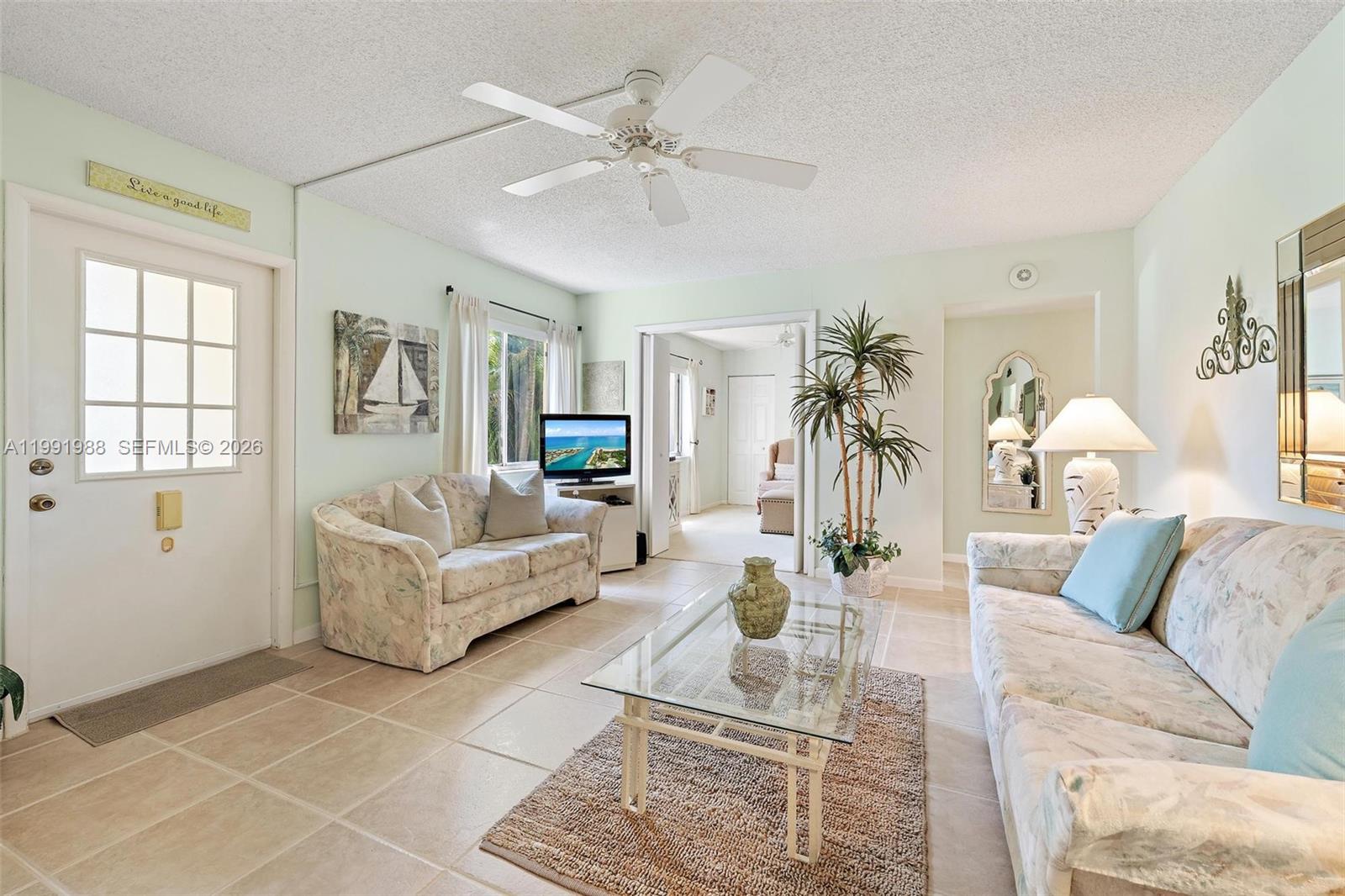 301 Pine Ridge Circle, Unit C1 Greenacres, FL 33463 - Photo 7 of 30 a living room with furniture and a large window
