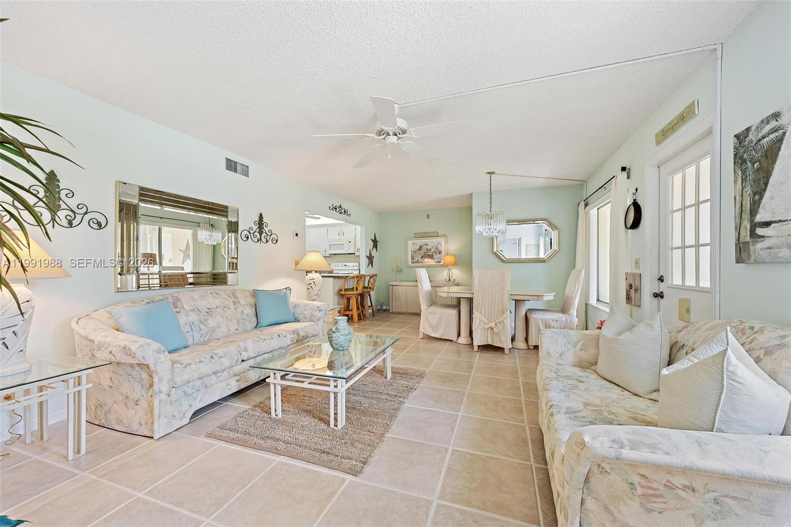 301 Pine Ridge Circle, Unit C1 Greenacres, FL 33463 - Photo 8 of 30 a living room with furniture and a large window