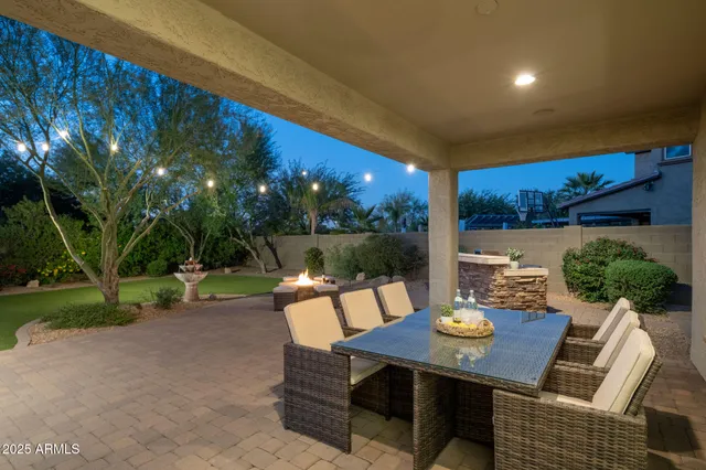a backyard of a house with a table and chairs