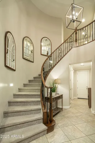 a living room with furniture a chandelier and a window