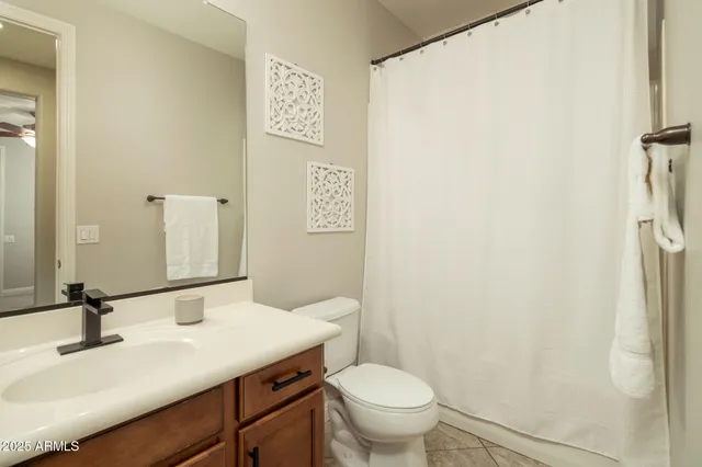 a living room with a flat screen tv and white walls