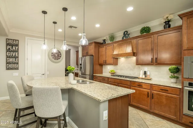 a kitchen with refrigerator and chairs
