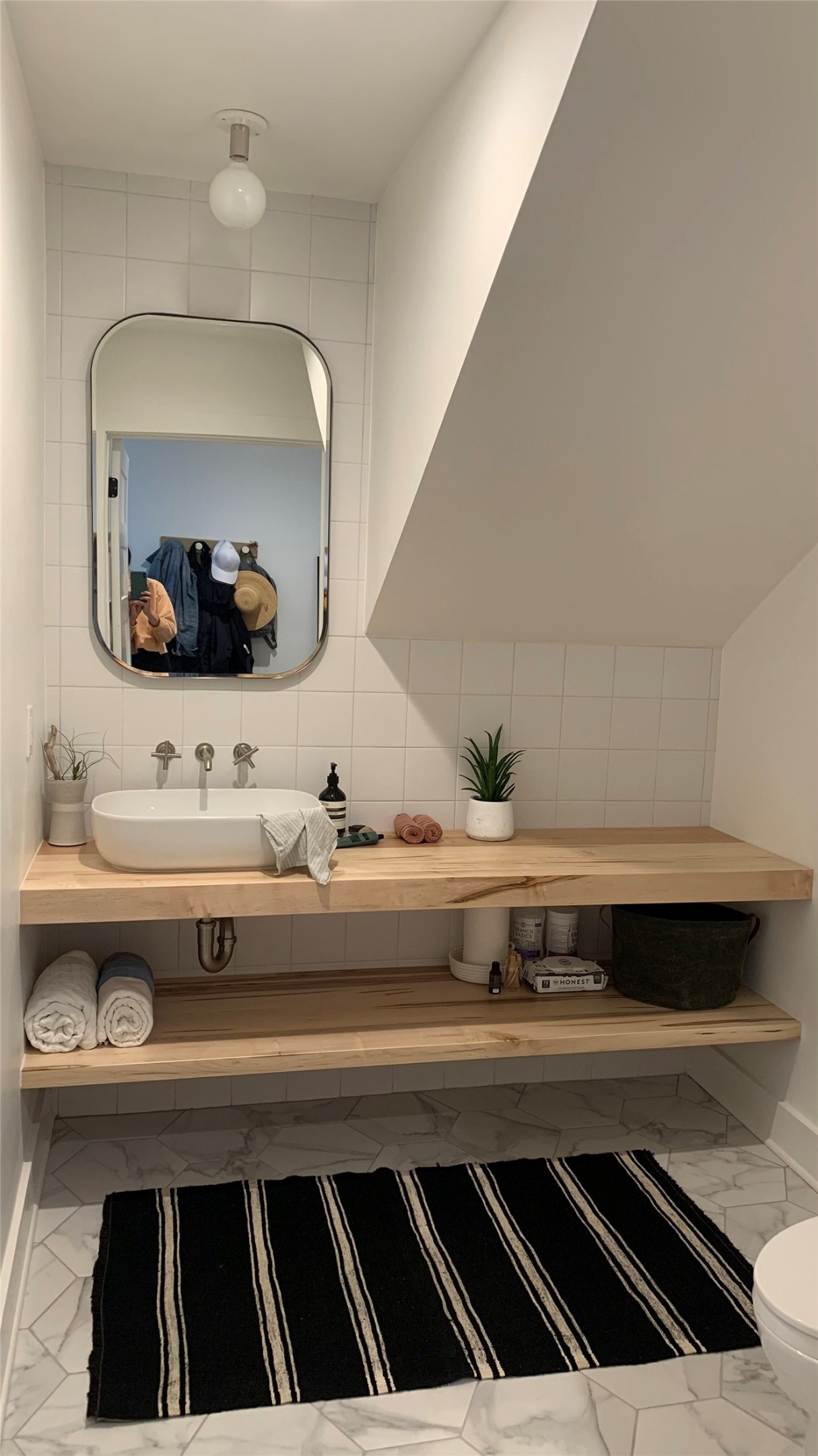 1816 Adina Street, Unit 2 Austin, TX 78721 - Photo 18 of 25 Modern bathroom featuring a rectangular vessel sink with wall-mounted faucet, wood-finish floating vanity, and hexagon tile flooring