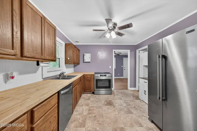 a kitchen with a sink stove and refrigerator