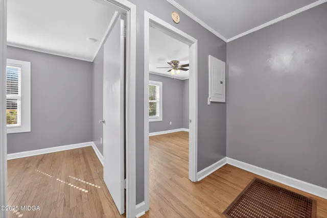a view of hallway with wooden floor