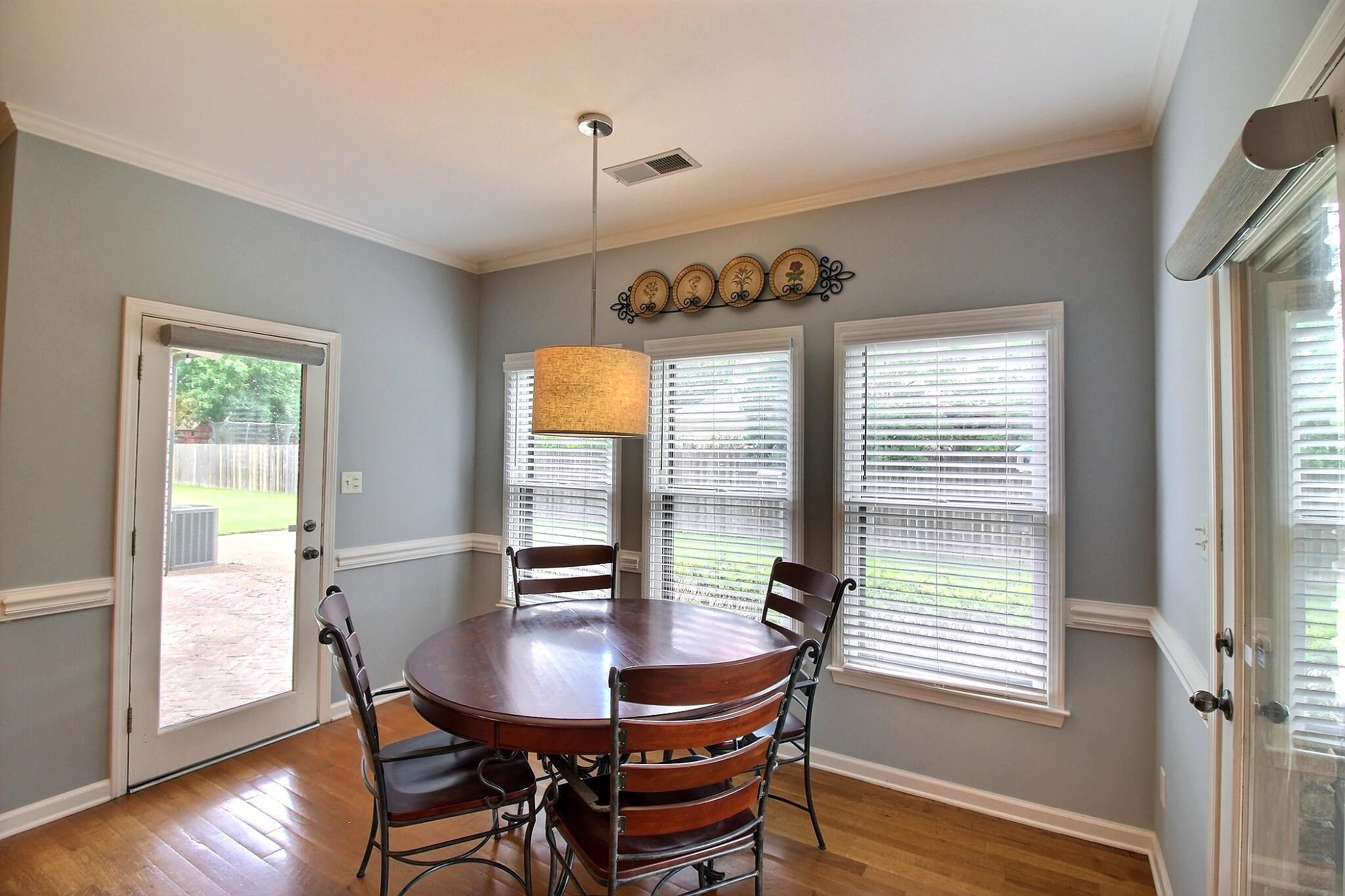 1156 Sunriver Cove Collierville, TN 38017 - Photo 11 of 37 a view of a dining room with furniture and wooden floor