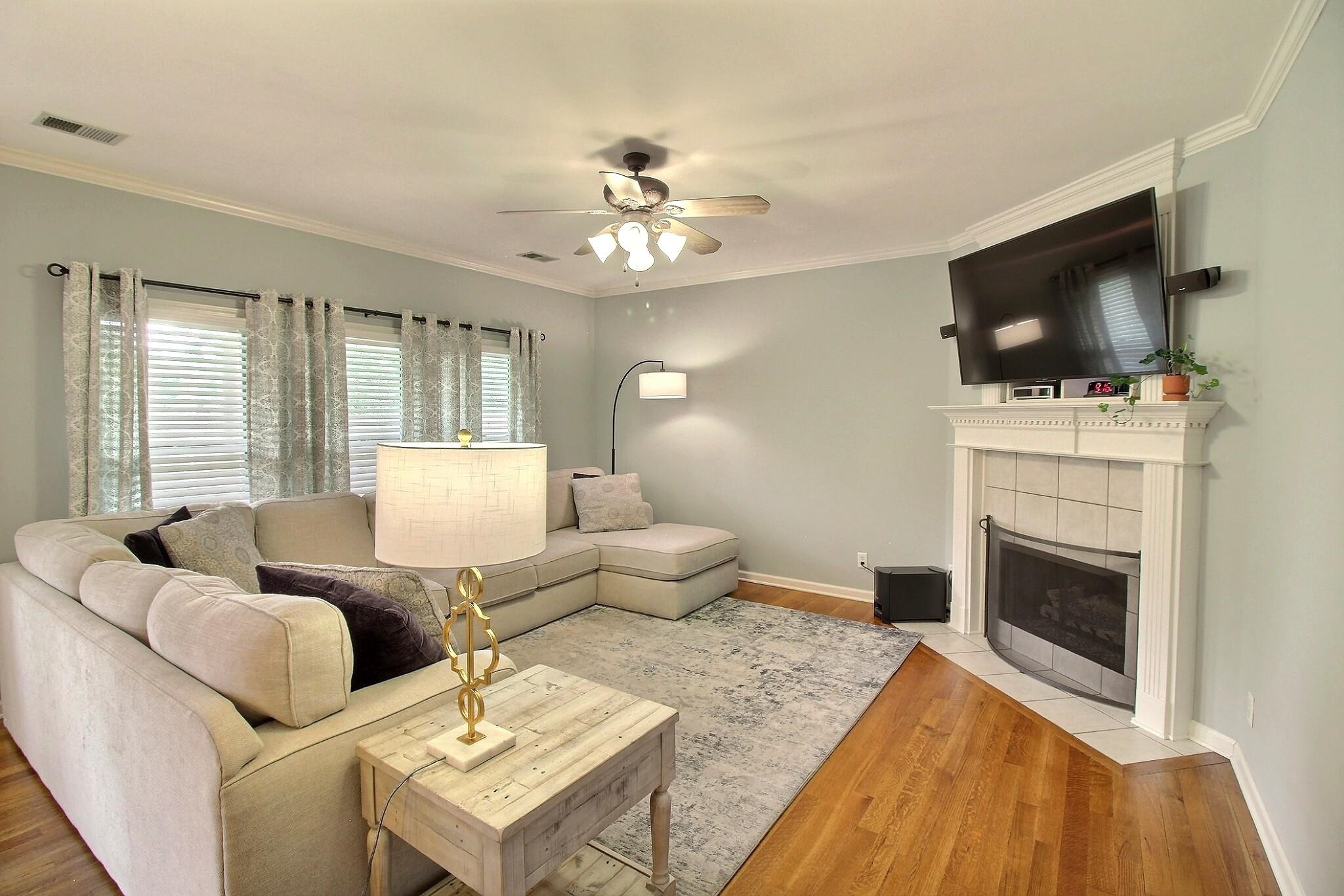 1156 Sunriver Cove Collierville, TN 38017 - Photo 12 of 37 a living room with furniture a flat screen tv and a fireplace