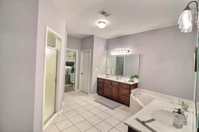 a spacious bathroom with a granite countertop sink and a mirror