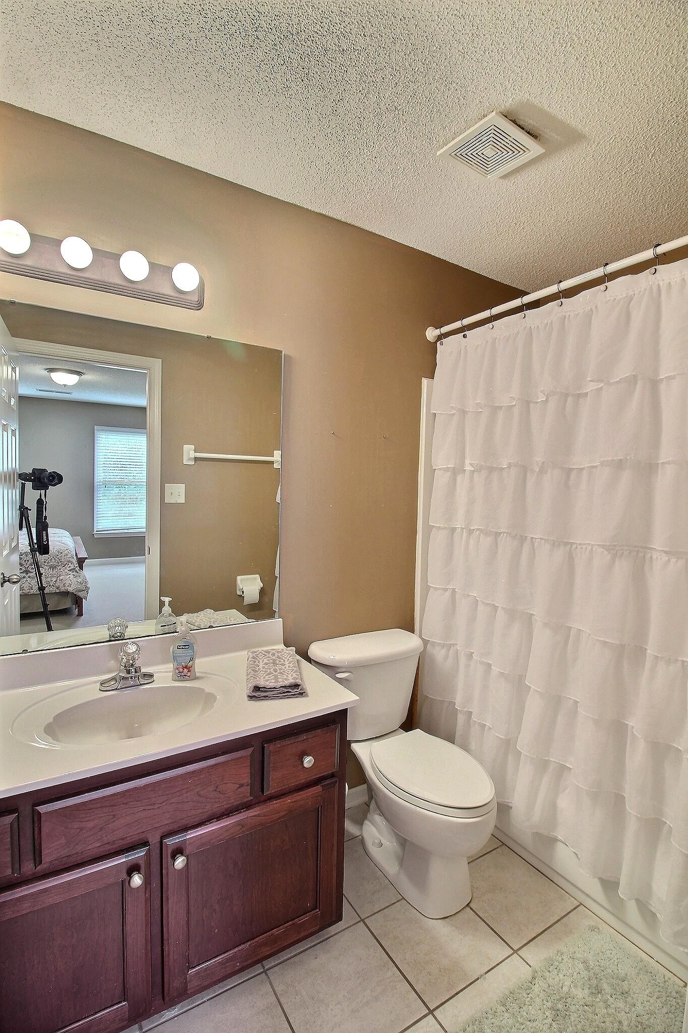1156 Sunriver Cove Collierville, TN 38017 - Photo 22 of 37 a bathroom with a toilet a sink and a mirror