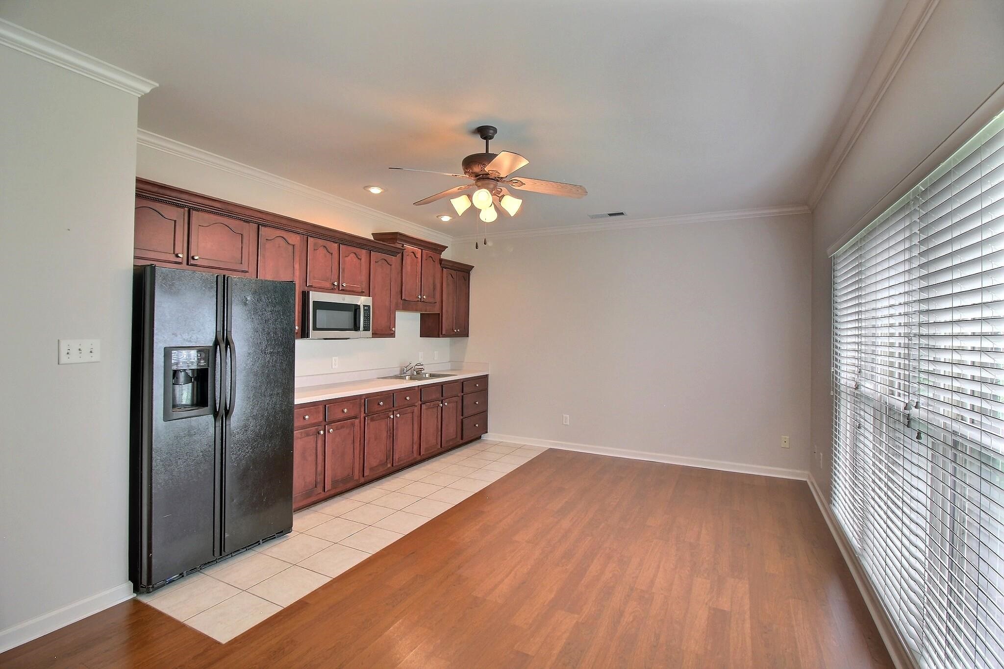 1156 Sunriver Cove Collierville, TN 38017 - Photo 25 of 37 a kitchen with stainless steel appliances granite countertop a refrigerator a sink dishwasher a stove and white countertops with wooden floor