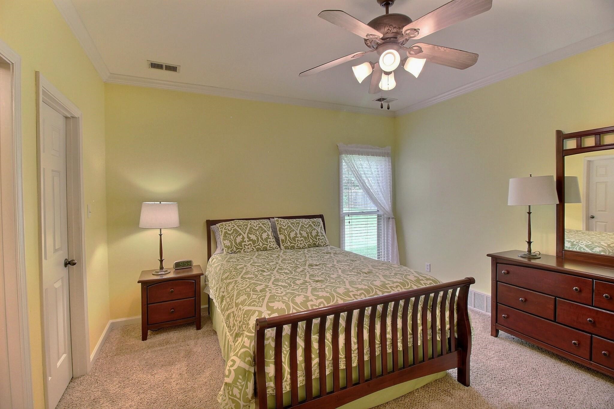 1156 Sunriver Cove Collierville, TN 38017 - Photo 26 of 37 a bedroom with a bed and a chandelier