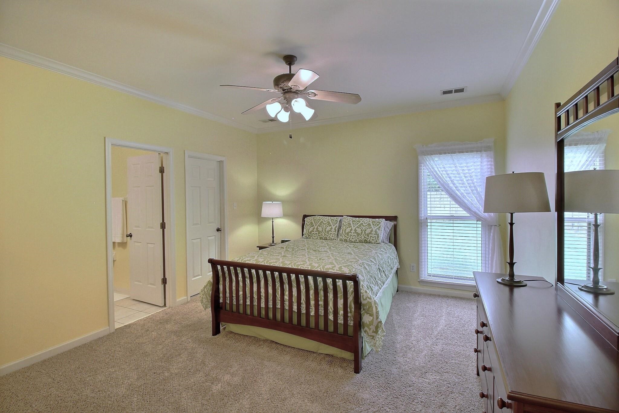1156 Sunriver Cove Collierville, TN 38017 - Photo 27 of 37 a spacious bedroom with a bed and a chandelier