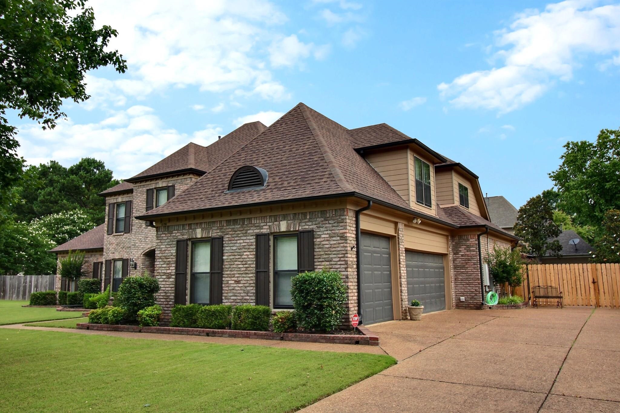 1156 Sunriver Cove Collierville, TN 38017 - Photo 4 of 37 a front view of a house with a yard and garage