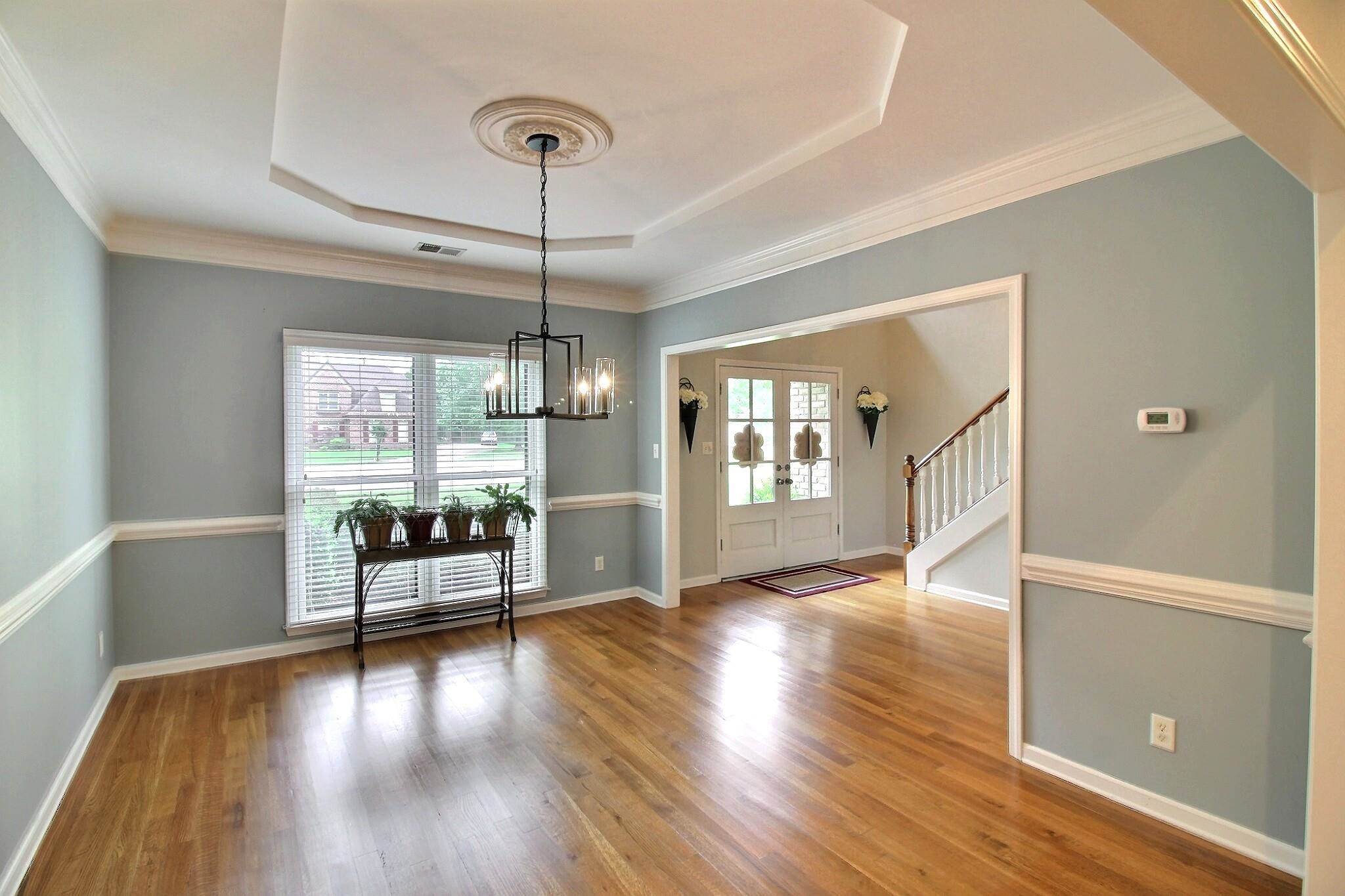 1156 Sunriver Cove Collierville, TN 38017 - Photo 6 of 37 a view of a livingroom with wooden floor a ceiling fan and windows