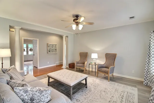 a living room with furniture a window and a chandelier