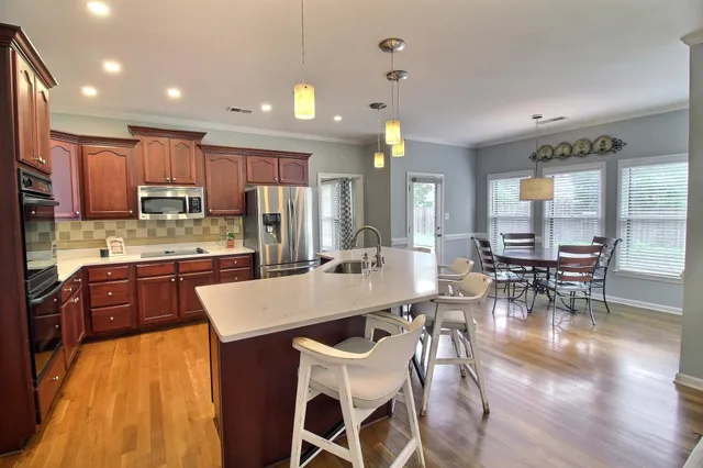 a large kitchen with a table and chairs