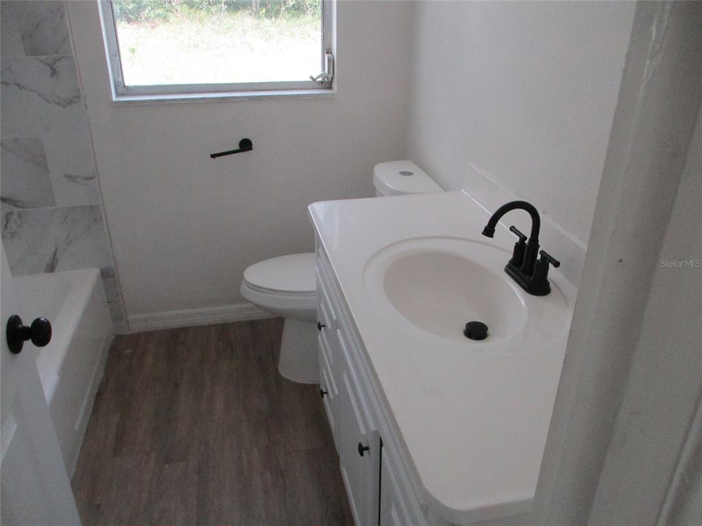 7925 Bracken Drive Port Richey, FL 34668 - Photo 9 of 11 a bathroom with a sink and a toilet