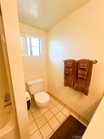 a spacious bedroom with a bed and ceiling fan