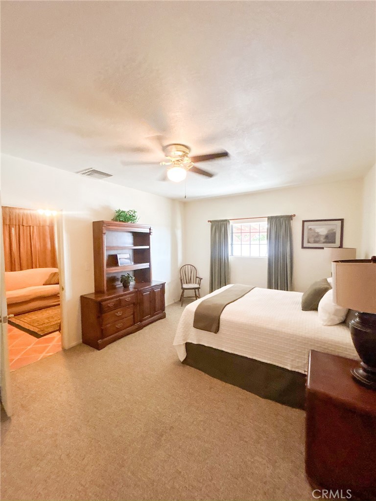 2153 Florence Boulevard Blythe, CA 92225 - Photo 12 of 38 a bedroom with a bed and wooden floor