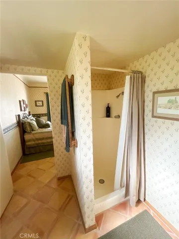 a bathroom with a toilet a sink and a mirror